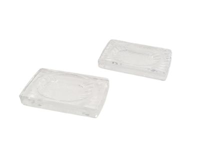 pair of clear plastic soap dishes on a white background
