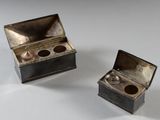 two silver boxes that are sitting next to each other