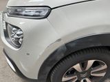 a close up of the front end of a white car