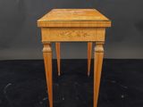 a small wooden table with a drawer on top of it