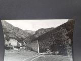 black and white photograph of a road with a mountain in the background
