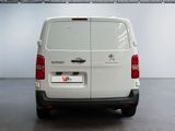 the rear of a white van is parked in a garage