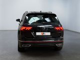 the rear end of a black volkswagen suv parked in a white room