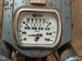a close up of a clock on the handlebar of a motorbike
