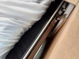 a bed in a box with a sheet on top of it