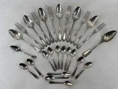 un grand nombre de cuillères et de fourchettes en argent disposées en cercle