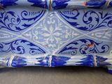 a blue and white vase sitting on a table