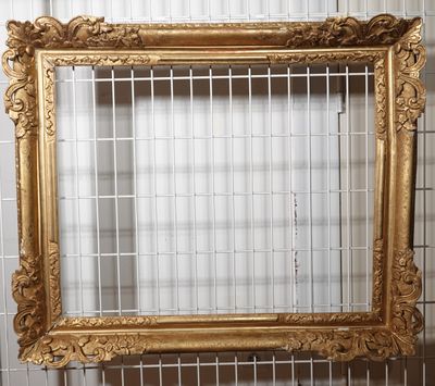 a picture of a gold frame hanging on a wall