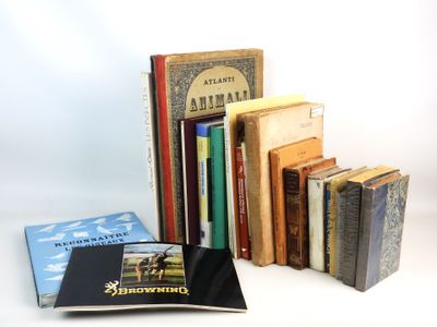 several books are stacked on top of each other on a white surface