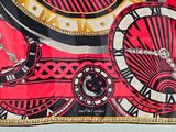 a red and black scarf with a clock on it