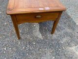 a small wooden table with a drawer on top of it