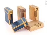 trois briquets dorés et bleus posés les uns à côté des autres sur une surface blanche