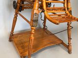 a wooden high chair with a wooden seat on a stand