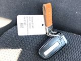 a car key that is attached to the seat belt of a car