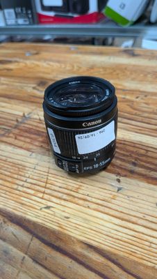 a close up of a camera lens sitting on a wooden table