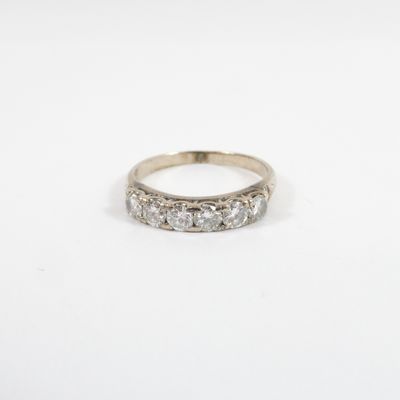 a white gold ring set with three round brilliant cut diamonds