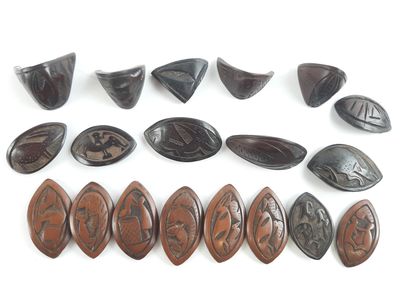 several pieces of carved wood are arranged on a white surface
