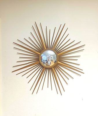 a picture of a sunburst on a wall in a living room