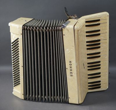 an old accordion sitting on top of a gray surface
