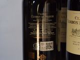 three bottles of wine are lined up on a table