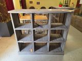 a wooden shelf with several shelves on it in a room