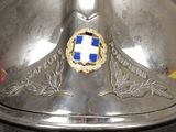 a silver helmet with a blue and white emblem on it