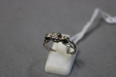 une photo d'une bague en diamant posée sur un bloc de marbre blanc