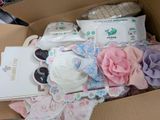 a cardboard box filled with a lot of baby items