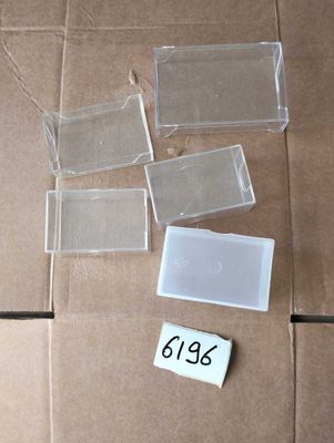 a cardboard box that has several pieces of plastic on top of it