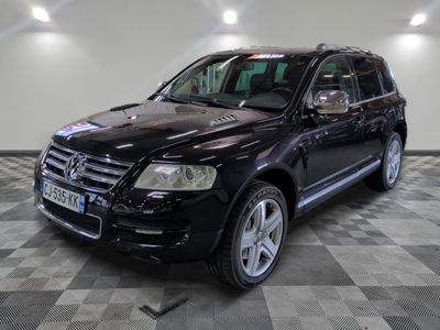 a picture of a black mercedes suv parked in a garage