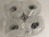 several rolls of toilet paper wrapped in plastic on a white surface