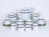 a white and blue tea set with cups and saucers
