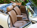 a white car with tan leather seats and a black bag