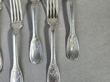 a lot of forks and spoons that are on the table