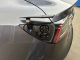 a close up of a car ' s rear end with an electric plug attached to it