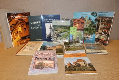 several books are sitting on a table in front of a wall