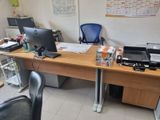 a desk with two computers and a printer on it