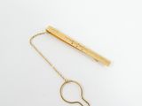 a gold plated necklace with a long chain attached to it