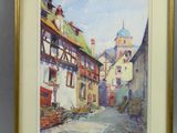 aquarelle encadrée représentant une scène de rue avec le clocher d'une église en arrière-plan