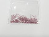 a small bag of pink glitter sitting on a table