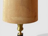 a lamp that is sitting on a table with a lamp shade on it