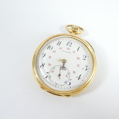 a close up of a pocket watch on a white surface