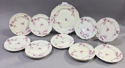 douze pièces de vaisselle en porcelaine rose et blanche sur fond gris