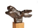 a bronze sculpture of a bird on a wooden base