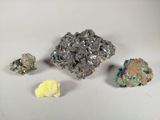 several different colored rocks are arranged on a white surface