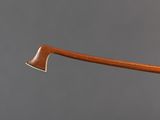a close up of an axe with a wooden handle on a gray background
