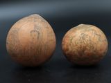 two eggs with designs on them sitting next to each other