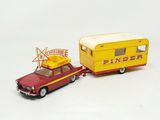 a toy car and a toy trailer on a white surface