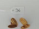 a pair of gold heart shaped earrings with a price tag