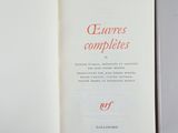 an open book with red writing on it sitting on a table